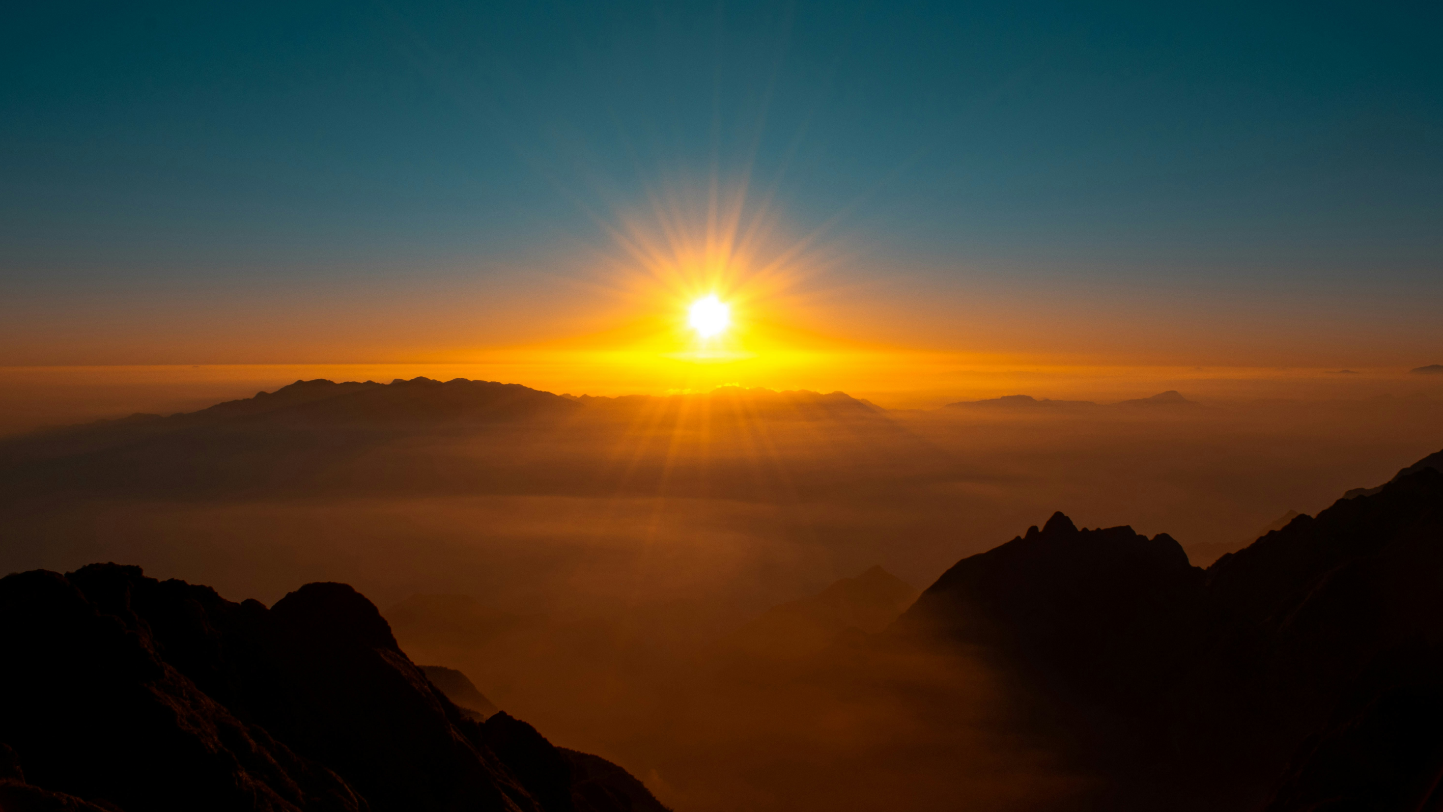 Sunrise over hazy mountains